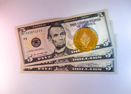 Five Us Dollars And Ethereum Cryptocurrency Stack On Table