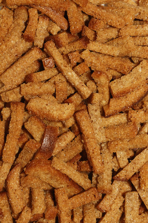 Golden crunchy bread sticks texture for culinary background and appetizing snack concept