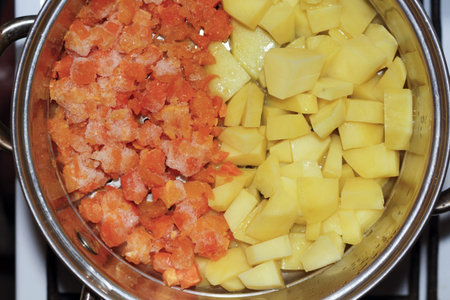 A vibrant culinary scene depicting diced potatoes in a stainless steel pot ready for cooking