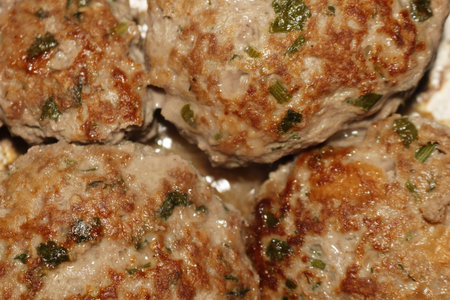 A delicious selection of homemade meatballs with fresh herbs on a plate for family dinner