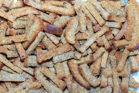 A pile of golden crunchy homemade croutons on a silver platter for festive meals and snacks