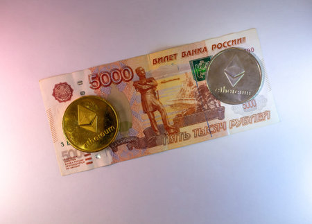 Russian Ruble Banknote With Ethereum Cryptocurrency Coins On Dark Backgroundのeditorial素材