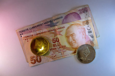 Turkish lira banknotes and ethereum cryptocurrency coins on white background