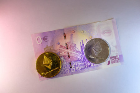Ethereum Cryptocurrency Coins Next To Euro Banknote On White Surfaceのeditorial素材