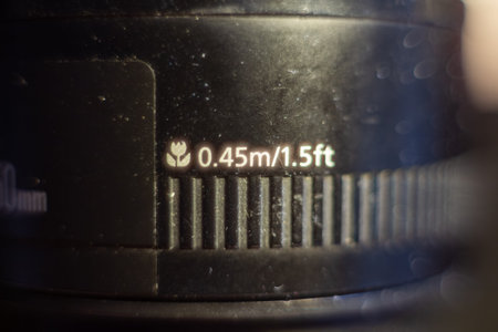 A detailed view of a camera lens distance scale with focus markings for precise photography