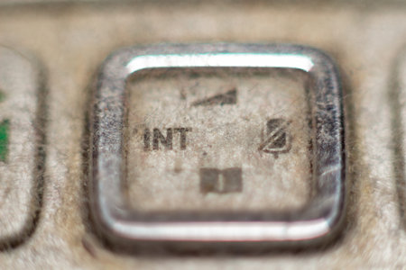 Isolated view of the insert key on a dusty old keyboard for data entry concepts