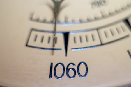 A detailed view of a precision instrument scale with the number one zero six zero