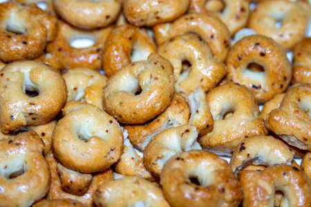 A large pile of golden savory snack rings on a white plate for party celebration or casual eating