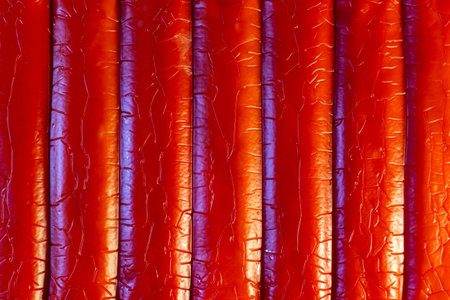 Abstract red textured background with vertical lines and dramatic lighting effects