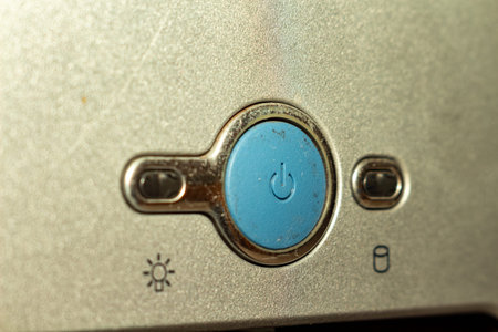 A detailed macro shot of a power button on an old appliance control panel with symbols
