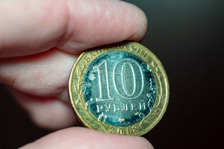 Ten russian rubles coin held in hand finance concept banking investment