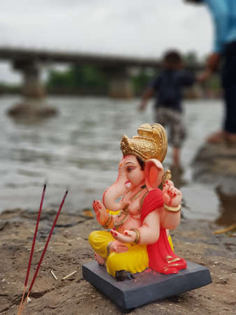 Small ganpati idol on the rock near the river side. Ganpati idol before ganpati visarjan.