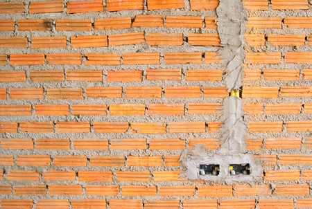 Expose brick wall and electric socketの写真素材