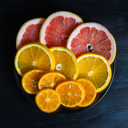 pieces of fresh citrus fruits (grapefruit, mandarin, orange)