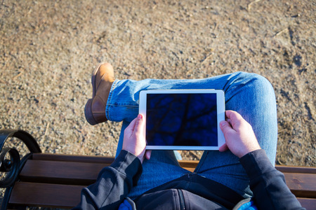 man using tablet computer outdoors