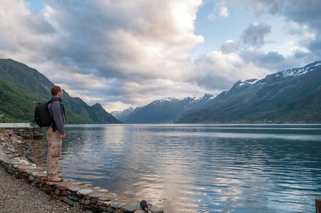 young man enjoying the view of fjord, Norwayの写真素材