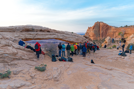UTAH, USA - APRIL 25, 2014: people are waiting for a sunrise at Mesa Arch in Canyonlands National Parkのeditorial素材