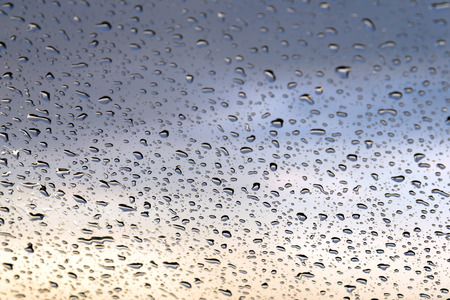 water drops on glass, sky backgroundの写真素材