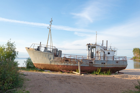 rusty old ship on the shoreの写真素材