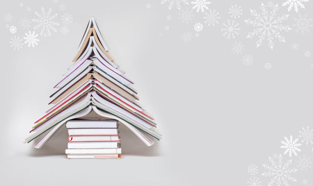 symbol Christmas tree from a colorful books on grey background. Empty copy space for your greetings
の写真素材