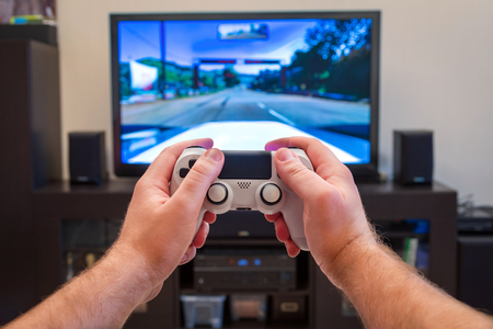 video game console controller in man handsの写真素材