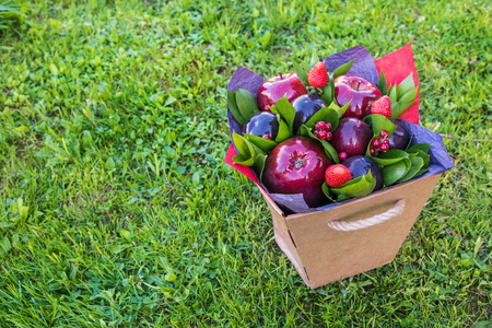 beautiful bouquet of berries and fruits (plum, apple, strawberry, currant)の写真素材