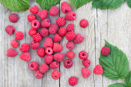 red raspberries on wooden backgroundの写真素材