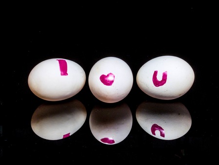 Boiled eggs isolated on black background with reflectionの写真素材