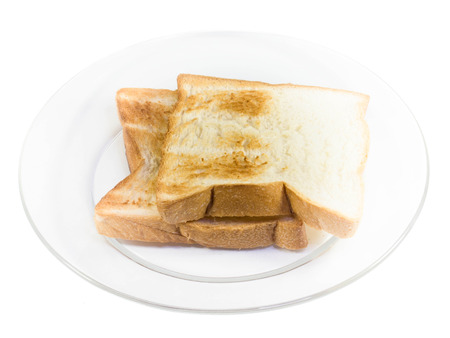 whole wheat bread on white diskの写真素材