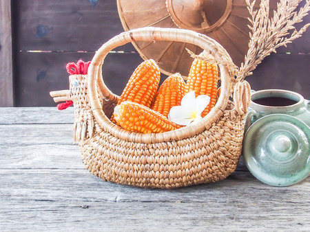 corn in basket, on wooden tableの写真素材