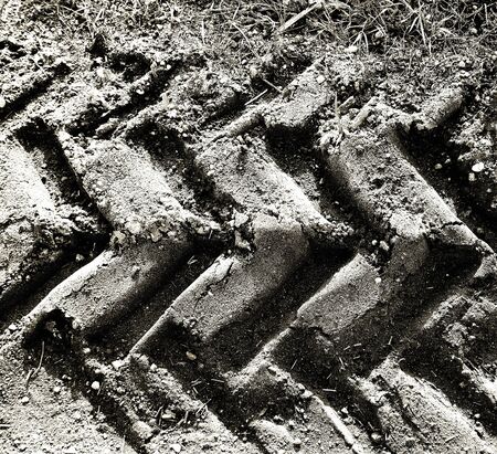 Tractor sand tracks. Agricultural natural ground mark backdrop. Tractor trace texture.