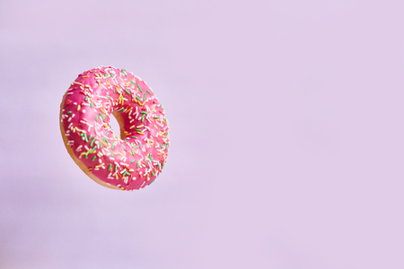 Pink donut on a pink background. Space for textの写真素材