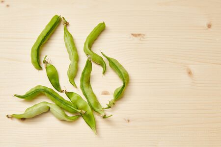 Ugly organic home grown pea on white wooden background. Trendy ugly food.Top view, copy space.