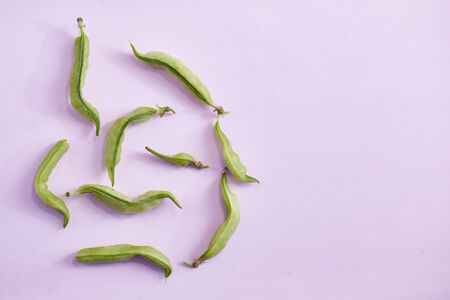 Ugly organic home grown pea on pink background. Trendy ugly food.Top view, copy space.