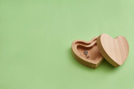 Wooden box. Heart with a key. green background horizontal image. Valentine's day background or...