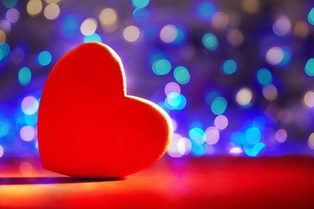 Greeting Card for Valentine's Day. Close-up red heart on defocus bokeh blue background. copyspace.の写真素材