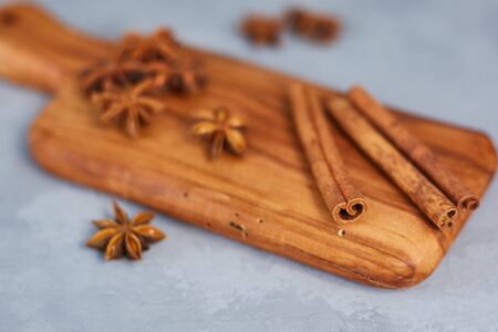 Anise, cinnamon on a wooden board. Close-up. Shallow depth of field.の写真素材