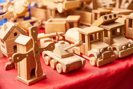 wooden toys on the table. Tank, miltsitsa, house, car. Shallow depth of field.の写真素材