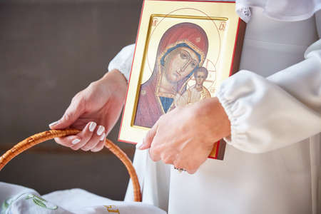 MOSCOW, RUSSIA - September 30, 2018. Women's hands hold the icon of the Christian church. Focus on eyes icons.のeditorial素材