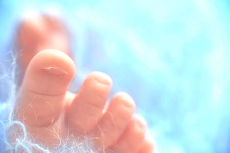 Close-up of the foot of a newborn baby boy. Copy spaceの写真素材