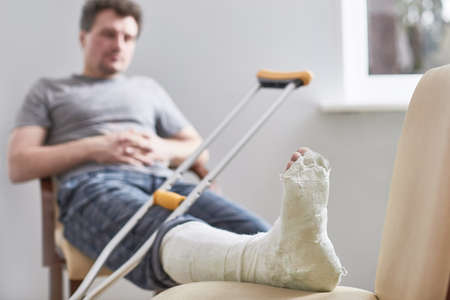Close up of a young mans Plaster leg cast and after a running injury or fallの写真素材