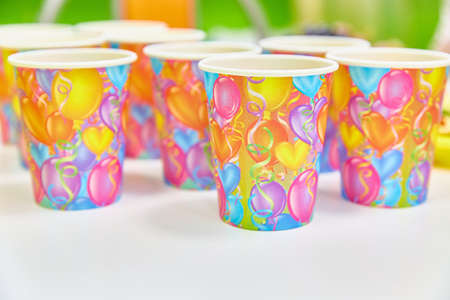 Greeting card with an invitation to a party. Festive paper cupsの写真素材