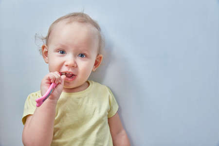 Baby girl brushing her teeth. opy spaceの写真素材