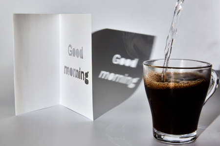 A cup of coffee and a good morning cardの写真素材
