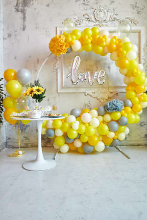 Photo zone of yellow and gray balloons. The party is decorated with balloons. Vertical imageの写真素材