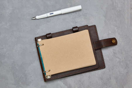 Design concept - Top view open notebook with kraft paper in a leather cover. Background for mockupの写真素材
