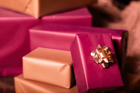 Boxes with Christmas gifts. Decor for New Year and Christmas. Colored birthday gifts with ribbon bow. stack Wrapped gifts.の写真素材