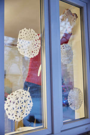 faceless person decorates the window before Christmas and new yearの写真素材