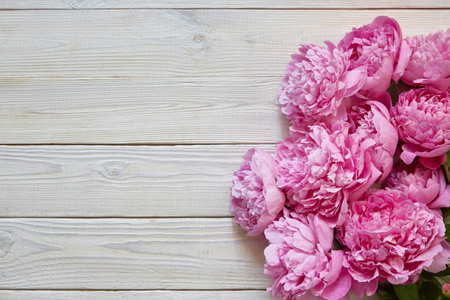 bouquet of peonies on a white wooden background with a copy space. A place for a text about Valentines day, mothers day, birthday.の写真素材