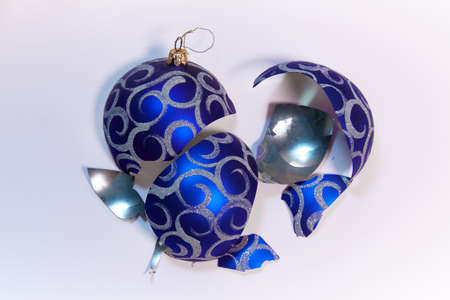 Broken Christmas blue ball close-up on a white backgroundの写真素材